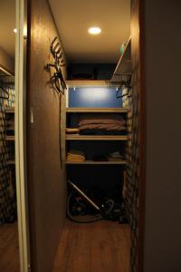 a walk in closet with some baseball equipment in it at Chaleureux meublé Chessy Proche Disney in Chessy