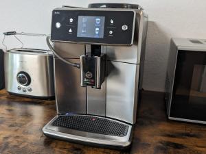 a coffee machine sitting on a table next to a toaster at Offline 51 City Apartments in Düsseldorf