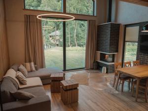a living room with a couch and a table at Vama Chalet in Vama Buzăului