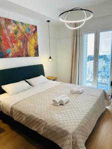 a bedroom with a bed with two towels on it at Aristotelous Square n.4 in Thessaloniki