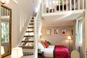 a room with a bed and a spiral staircase at La Villa Madame in Paris