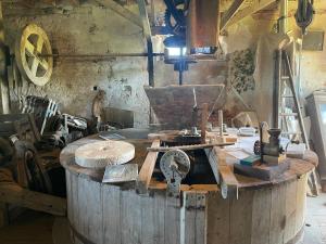 a room with a large wooden table with tools at Le Moulin de Mautheville in Grainville-la-Teinturière +34 photos