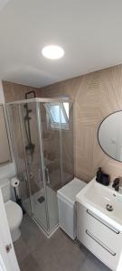 a bathroom with a shower and a toilet and a sink at Casita de diseño cerca del mar in El Puerto de Santa María +9 photos