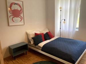 a bed with a blue comforter and pillows in a bedroom at Little Fine Apartment close to Leipzig in Zeitz