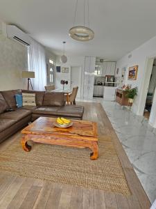 a living room with a couch and a coffee table at Apartments Tivat in Tivat +46 photos