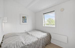 a white bedroom with a bed and a window at 3 Bedroom Gorgeous Home In Slagelse in Slagelse +4 photos
