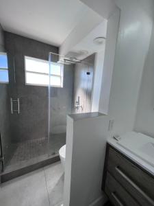 a bathroom with a shower and a toilet and a sink at Unique Water Views, free Parking 1bed 1 bath Rooffornomads 416 in Miami Beach +18 photos
