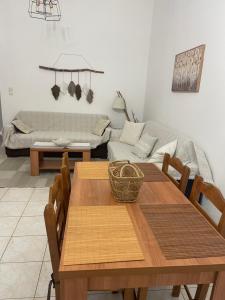 a living room with a table and a couch at Λούρος Πρέβεζα in Loúros