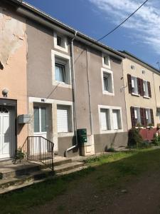 an apartment building with stairs in front of it at Gite de l'ancien Moulin in Le Val-dʼAjol