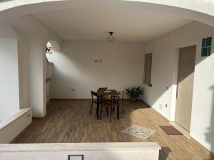 an empty living room with a table and chairs at Casa Marisol in San Giovanni Suergiu