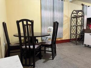 a dining room with a table and two chairs at Casa Marconi in Quetzaltenango +3 photos