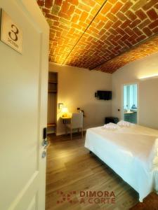 a bedroom with a bed and a table in a room at Dimora a Corte in Mathi