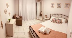 a bedroom with a bed with two towels on it at PerAmore Apartment in Nea Peramos