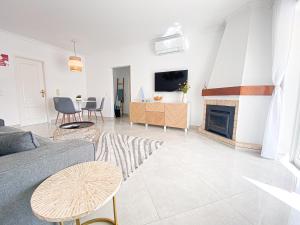 a living room with a couch and a fireplace at Casa Joao in Carvoeiro