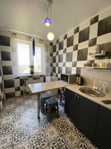 a kitchen with a table and a sink in it at Морской бриз in Odesa