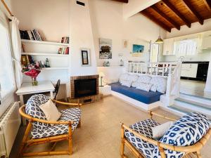 a living room with a bed and a fireplace at Casa Stefi - Astbury Formentera in Es Arenals