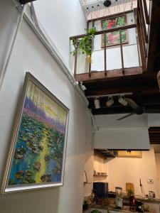 a large painting on a wall with a window at Homs Female Hostel in George Town