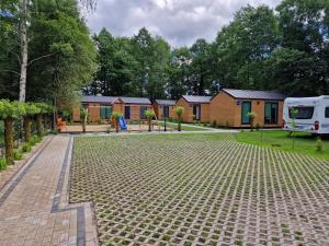 a caravan park with a rv parked in the driveway at Domki Wakacyjne "Morskie Wrota"Karwieńskie Błota in Karwieńskie Błoto Drugie