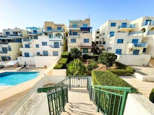 a view of a apartment complex with a swimming pool at Pelagos Panorama 2B, Seaview, Pool in Khlorakas