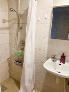 a shower curtain in a bathroom with a sink at Uuemõisa apart in Haapsalu