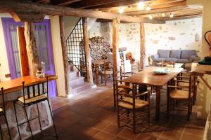 a room with a table and chairs and a couch at La Casona de Castilnovo - Gay Men Only in Valdesaz