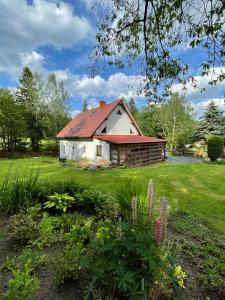 a house with a red roof in a yard at Stara Szlifiernia - dom na wyłączność in Szklarska Poręba