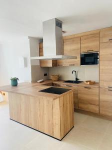 a kitchen with a wooden island with a sink at Eco del Mar in Cala d´Or