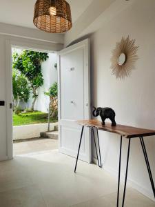 a black cat sitting on a wooden table in a room at Eco del Mar in Cala d´Or +22 photos