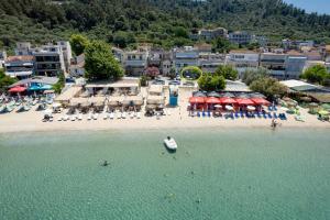 an aerial view of a beach with chairs and umbrellas at Chara Sea View Luxury House in Limenas