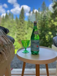 a bottle and a glass sitting on a table at KoloCabins - Hiitolanjoki 3 in Simpele