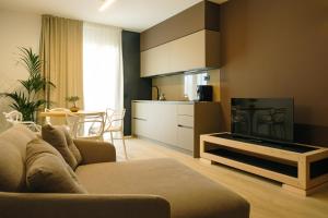 TV a/nebo společenská místnost v ubytování Camoma Aparthotel - Suites Apartments