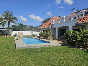 a house with a swimming pool in a yard at Sound of the Sea Villa PD in Port Dickson