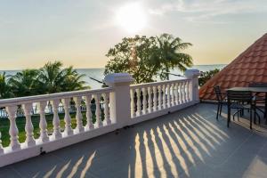 a balcony with a white railing and a view of the ocean at Sound of the Sea Villa PD in Port Dickson