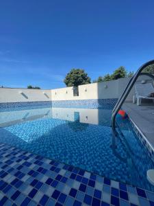 a swimming pool with a blue and white tile floor at Villa Ivanovic in Budva
