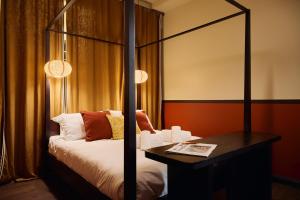 a bedroom with a bed and a table with a mirror at Maison Luxury Pantheon in Rome