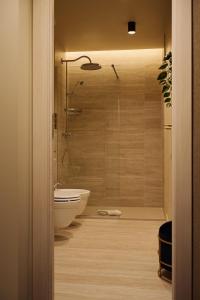a bathroom with a shower and a white bath tub at Maison Luxury Pantheon in Rome