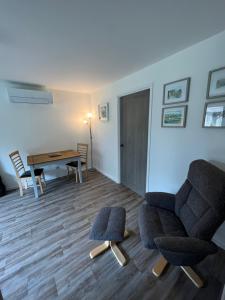 a living room with a chair and a table at The Wee Hoose near Loch Ness, private garden, private parking in Drumnadrochit