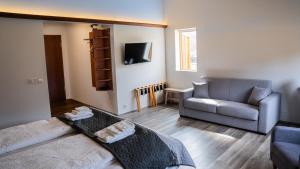 a living room with a couch and a chair at Hótel Flókalundur in Brjánslækur