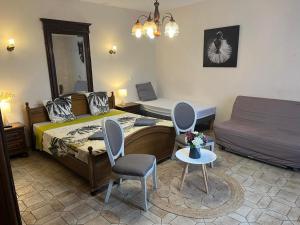 a bedroom with a bed and a bed and a couch at Le Saint André in Villers-sur-Port