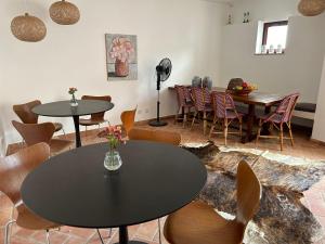 a room with two tables and chairs and a table with flowers at Casa d´Alte in Alte +44 photos