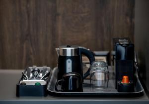 a tray with a coffee maker and other appliances on a counter at sarti luxury diaMoNd in Sarti