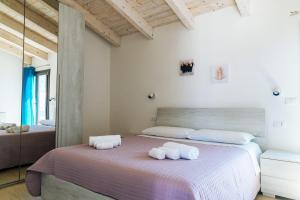 Posteľ alebo postele v izbe v ubytovaní Casa Vacanze Oltre La Caletta - 350 mt dalla spiaggia