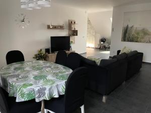 a living room with a couch and a table at Belle Apartman in Balatonlelle