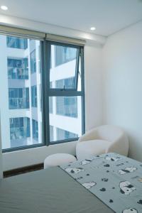 a bedroom with a bed and a large window at HOMESTAY nhà Trang in Hai Phong
