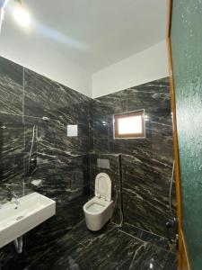 a bathroom with a toilet and a sink at Green Garden Villa in Ksamil