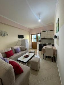 a living room with a couch and a table at Green Garden Villa in Ksamil