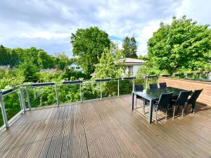 a wooden deck with a table and chairs on it at Spacious Family Apartment by the Sea in Jūrmala +14 photos
