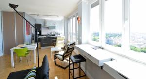 an apartment with a kitchen and a living room with windows at Appart' Belvedere in Lyon