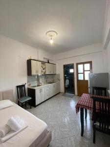 a bedroom with a bed and a desk and a table at Green Garden Villa in Ksamil +47 photos