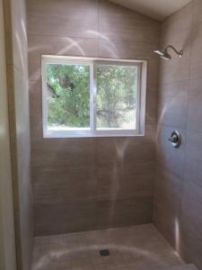 a bathroom with a shower and a window at Loyah Cabin in Ahwahnee +20 photos